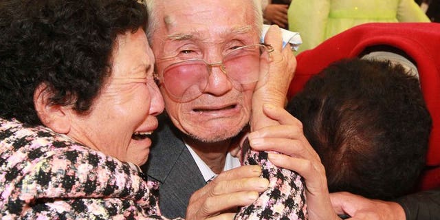 North Korean Kim Jin-Won (centre) cries with his South Korean relatives as they bid farewell following their three-day separated family reunion meeting at Mount Kumgang resort on the North's southeastern coast, near the border, on November 1, 2010. South and North Korea agreed Friday to go ahead with reunions next month for families separated for decades by the 1950-53 Korean War, Seoul said.