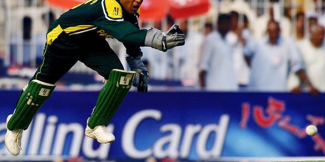 Pakistani wicketkeeper Rashid Latif leaps in an attempt to field a ball in Faisalabad, on October 7, 2003. The Pakistan Cricket Board said Friday that former captain Latif must apologise or provide proof supporting his claims that an alleged bookie was their guest in 2005.