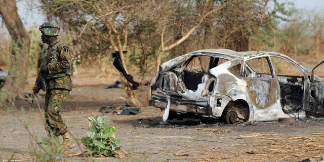 Nigerian soldiers patrol close to a former Boko Haram camp on June 5, 2013 near Maiduguri. Suspected members of Islamist extremist group Boko Haram have attacked a village in northeastern Nigeria, killing at least 35 people and wounding 14, the military said on Friday.