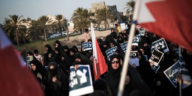Bahraini women carry posters during an anti-government rally in the village of Abu Saiba, west of Manama, on August 23, 2013. Shiite protesters took to the streets in Bahrain Friday demanding political reforms in the Sunni-ruled Gulf kingdom, witnesses said.