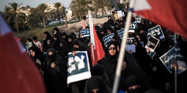 Bahraini women carry posters during an anti-government rally in the village of Abu Saiba, west of Manama, on August 23, 2013. Shiite protesters took to the streets in Bahrain Friday demanding political reforms in the Sunni-ruled Gulf kingdom, witnesses said.