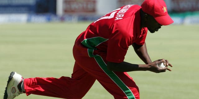 Zimbabwe's fielder Elton Chigumbura takes a catch in the deep during the second and final Twenty20 international between Zimbabwe and Pakistan at the Harare Sports Club on August 24, 2013. The home side looked to earn a share of the series on Saturday.