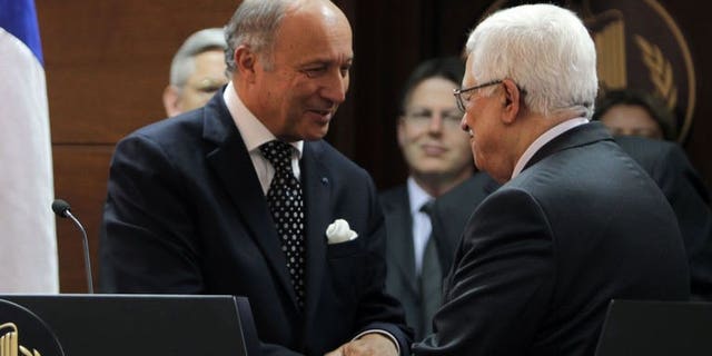 French Foreign Minister Laurent Fabius meets Palestinian President Mahmoud Abbas (R) on August 24, 2013 in Ramallah, the West Bank. A succesful outcome to the Israel-Palestinians negotiations would be like a "thunderbolt" for peace in the crisis-ridden Middle East, Fabius said.