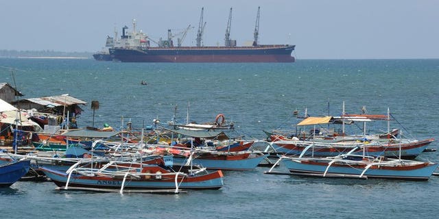 Philippine fishing boats are anchored near a foreign cargo vessel facing the South China sea at the port of Santa Cruz, Zambales province, north of Manila on May 10, 2012. The United States and the Philippines have vowed to maintain freedom of navigation in a Southeast Asia increasingly beset by maritime territorial rows, the two military allies said.