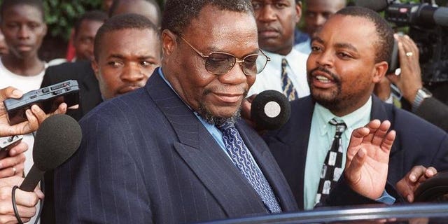 Zimbabwe's then Minister of Land and Agriculture Kumbirai Kangai leaves Harare Magistrates Court March 21, 2000. Kangai, a close ally of President Robert Mugabe and key leader in the fight to end British rule, died Saturday, a party official said.