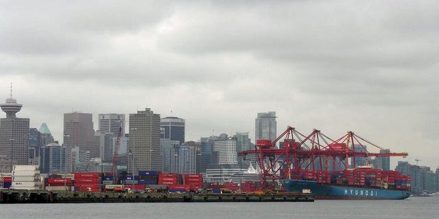 A container ship unloads in 2005 at the P&O Central Terminal in the Port of Vancouver. Canada's trade deficit doubled in July as imports increased and exports declined, the government statistical agency said Wednesday.
