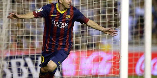 Barcelona's Argentinian forward Lionel Messi celebrates after scoring a goal against Valencia at the Mestalla stadium in Valencia on September 1, 2013. Messi and his father have repaid five million euros ($6.6 million) owed to the taxman before facing court on tax evasion charges, according to a judge's ruling.