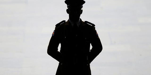 A Sri Lankan police official keeps watch in Colombo, on May 31, 2013. Sri Lankan police say a man died after a bizarre and botched ritual to drive out what he thought were evil spirits from a house outside Colombo.