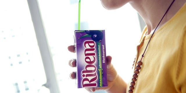 A woman sips a Ribena drink in London, March 28, 2007.