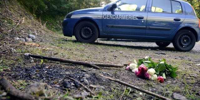 A French gendarmerie car is parked on September 8, 2012, at the place where three members of a British-Iraqi family and a local man were shot dead in the French Alpine village of Chevaline. French and British investigators say they have made significant progress in the brutal quadruple murder.