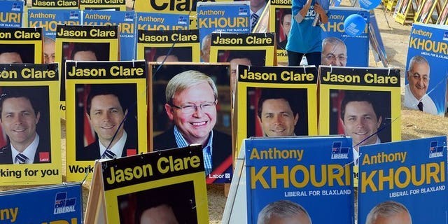 Portriats of the election contestants are seen in front of a pre-poll voting centre in Sydney, on September 6, 2013.