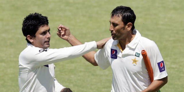 Pakistan batsman Younis Khan (right) is congratulated by Adnan Akmal (left) during the fourth day of the first cricket Test against Zimbabwe in Harare on September 6, 2013. Pakistan beat Zimbabwe by 221 runs on the fifth day.