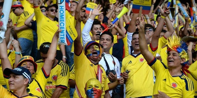 Colombian supporters cheer for their team before the start of the FIFA World Cup Brazil 2014 qualifying match against Ecuador at the in Barranquilla on September 6, 2013. An alleged drug don, Claudio Baez, was arrested in Colombia as he headed to the football match, police said Saturday.