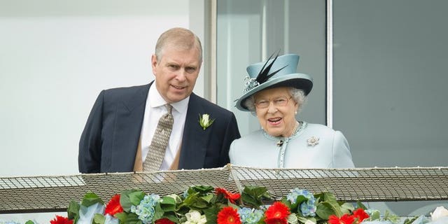 Prince Andrew, the Duke of York, speaks to Queen Elizabeth II at the Epsom Derby Festival in England on June 1, 2013. Prince Andrew was challenged by jittery royal protection officers in the gardens of Buckingham Palace last week as they stepped up security following a break-in, police admitted on Sunday.