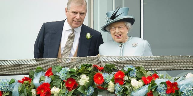 Prince Andrew, the Duke of York, speaks to Queen Elizabeth II at the Epsom Derby Festival in England on June 1, 2013. Prince Andrew was challenged by jittery royal protection officers in the gardens of Buckingham Palace last week as they stepped up security following a break-in, police admitted on Sunday.