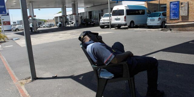 A petrol attendant takes a break in Cape Town. Tens of thousands of South African petrol attendants and car repair workers will strike for higher wages and better conditions, their union said, as stoppages in other sectors wound down.