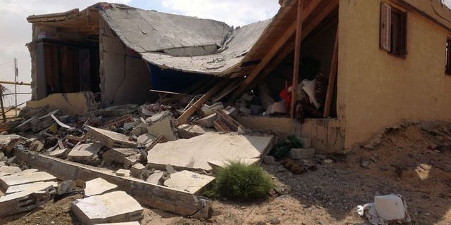 Damaged buildings are seen on September 3, 2013 in al-Toma village on the outskirts of Egypt's northern Sinai town of Sheikh Zuweid. after it was hit during an army operation. Egyptian military helicopters carried out a second day of air raids in the Sinai Peninsula, where they are facing an insurgency by Islamist militants, witnesses said.