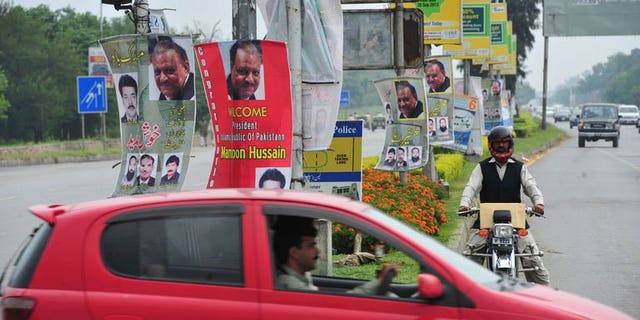 Roadside banners welcoming and congratulating incoming Pakistani President Mamnoon Hussain are pictured in Islamabad on September 9, 2013.