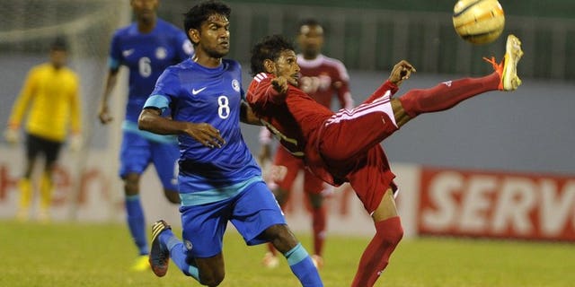 India's Francisco Fernandens (left) vies with Maldives' Akram abul Gani (right) during their SAFF Championships semi-final football match in Kathmandu on September 9, 2013. India won 1-0. The Maldives' football coach has blamed a disputed penalty decision for flared tempers after his team's 1-0 loss to India which saw a player assault the referee and the police called in to restore calm.
