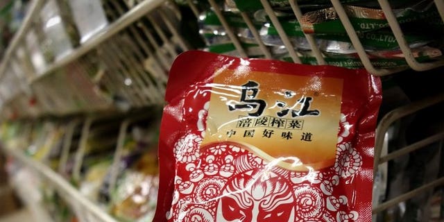Fuling Zhacai -- pickled root vegetable -- is seen on sale at a supermarket in Beijing on August 14, 2013. Shares in a Chinese food company became one of the market's hottest stocks on Tuesday after Xi Jinping gave its spicy pickles the presidential stamp of approval.
