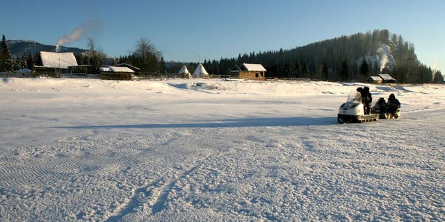 Members of an electoral voting commission drive a snowmobile to villagers in the remote Siberian village of Shor-Taiga on December 1, 2007. Russian authorities have found a young man living alone in a Siberian forest after having apparently spent most of his life living there in a hut with his parents, local officials said Tuesday.