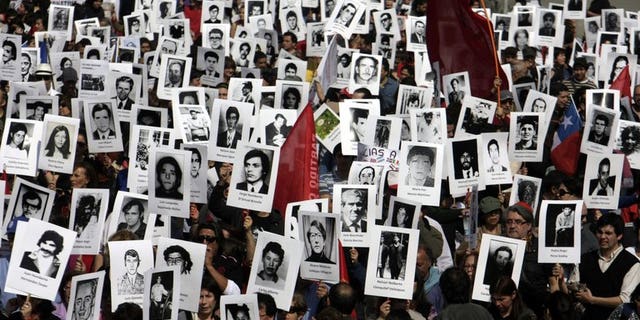 Chilean human rights activists take part in a demonstration in Santiago on September 8, 2013. A thousand people lay on the ground Tuesday in Chile's capital in memory of those still missing from the dictatorship of Gen. Augusto Pinochet.
