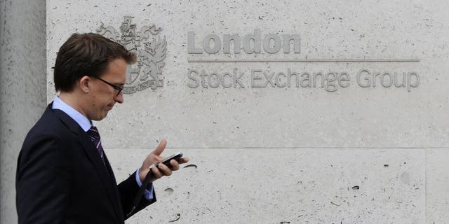A man walks past the London Stock Exchange, in central London, on September 22, 2011. London shares edged fractionally higher on Wednesday, with traders cautious despite a possible deal aimed at preventing a US-led military attack on Syria.