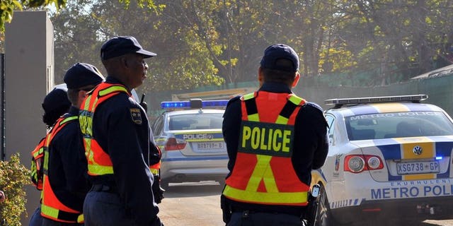 Police stand guard in Johannesburg on May 27, 2010. South African police on Wednesday fired rubber bullets and tear gas at protesters who took to the streets in Johannesburg in anger over the lack of government services.