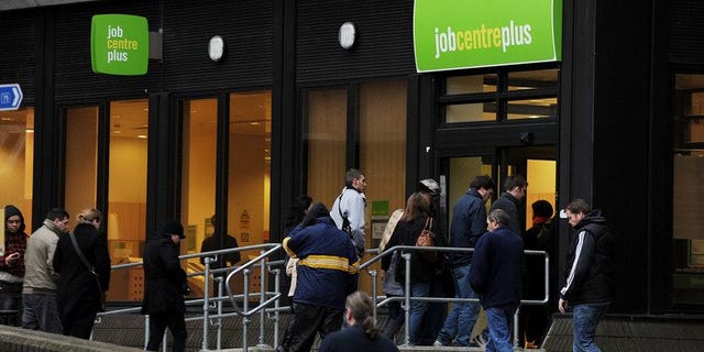 People enter a job centre in Bromley on January 20, 2010. Britain's unemployment rate eased to 7.7 percent in the three months to July, official data showed.