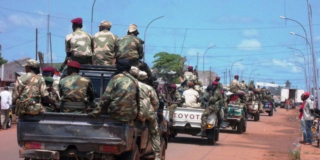 Troops in charge of disarmament ride through the Central African Republic capital Bangui on September 5, 2013. Almost 100 people have died this week in two days of fighting between the new Central African Republic president's forces and those loyal to ousted leader Francois Bozize, the presidency said Wednesday, updating an earlier toll.