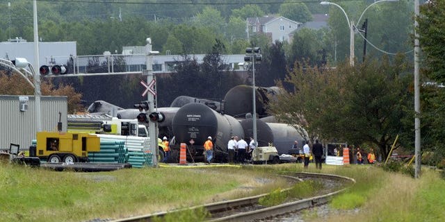 Investigators work at a train derailment site July 9, 2013 in Lac-megantic, Quebec, Canada.