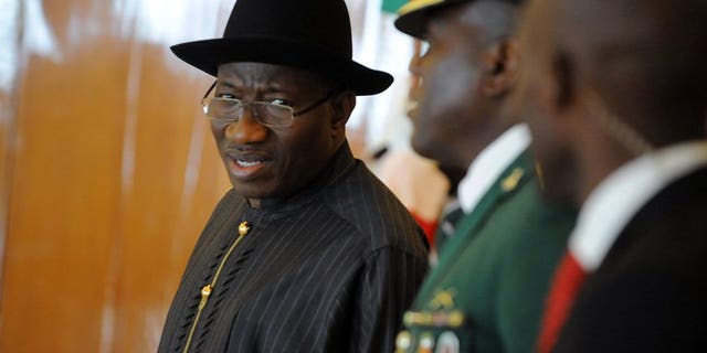 Nigerian President Goodluck Jonathan (L) in Abuja on July 18, 2013.