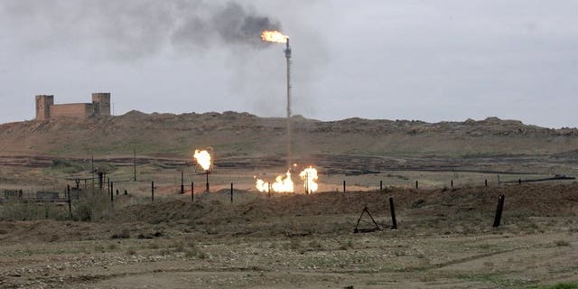 Flares burn at the Northern Kirkuk Oil in northern Iraq on January 6, 2010.