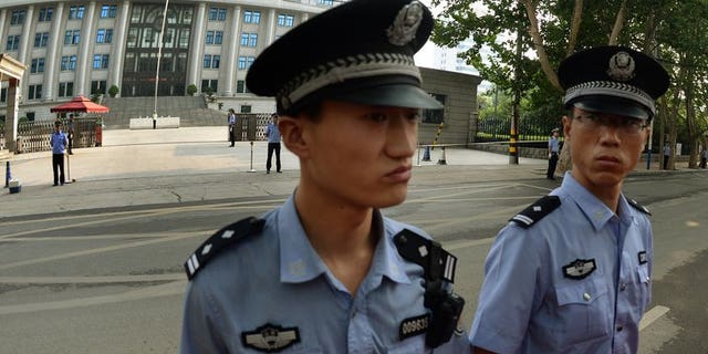 Illustration: Police outside a court in Beijing, where disgraced politician Bo Xilai was tried for graft