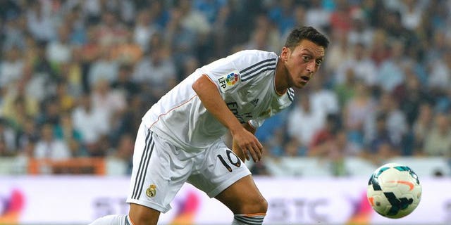 Then-Real Madrid midfielder Mesut Ozil eyes the ball during their Spanish league match against Real Betis in Madrid on August 18, 2013. Record Arsenal signing Mesut Ozil said on Thursday that he believes the club can challenge for the English Premier League title this season.