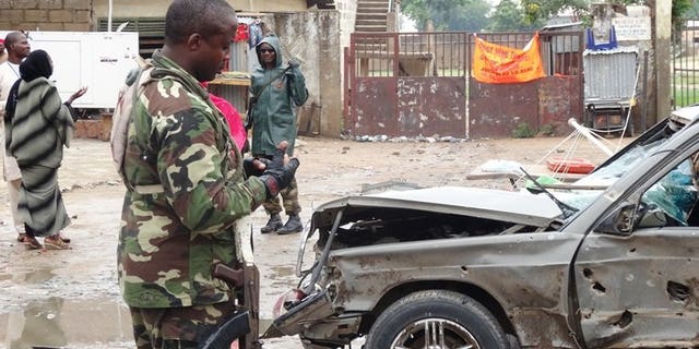 A soldier stands at the scene of an explosion in the downtown Sabon Gari neighbourhood of Kano on July 30, 2013.