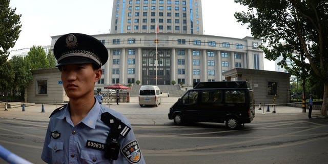 Police stand guard outside the Intermediate People's Court in Jinan, Shandong Province on August 25, 2013. Police on Friday detained an outspoken Chinese businessman who had called for the release of a prominent lawyer arrested as part of a crackdown on anti-corruption activists, a friend told AFP.