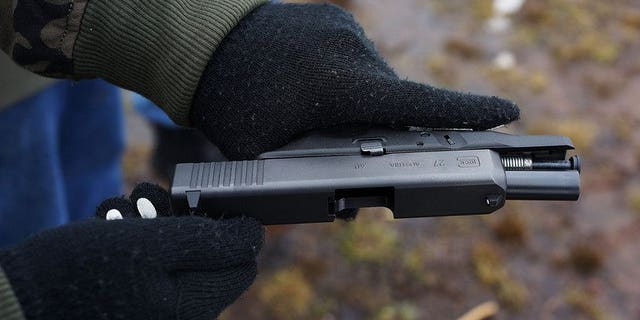 Students learn to fire their pistols at a shooting range on February 24, 2013 in Wallingford, Connecticut, US. A Kenyan woman has been spared jail for hiring hitmen kill her husband after the couple promised a judge that they had patched up their differences, reports said Friday.