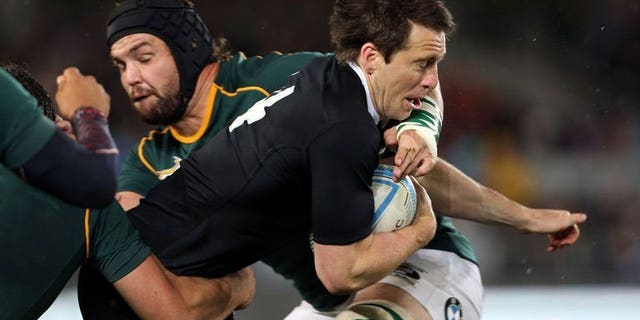 Ben Smith of New Zealand (right) is tackled by Flip van der Merwe of South Africa during their Rugby Championship Test in Auckland on September 14, 2013. New Zealand won 29-15.