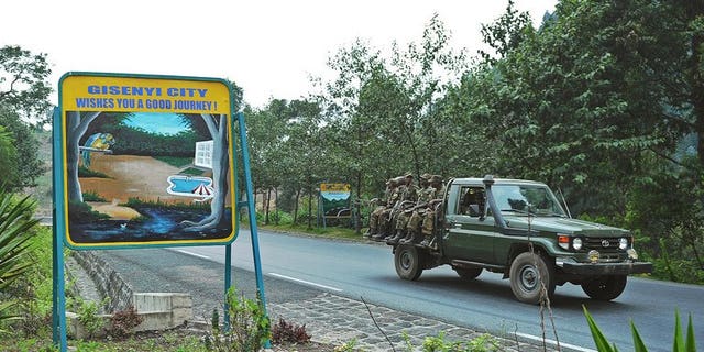 Rwandan soldiers pass a sign welcoming drivers to the city of Gisenyi, on the border with the Democratic Republic of Congo on August 30, 2013. Southern African nations have expressed concern at the growing number of Rwandan troops on the border of the Democratic Republic of Congo and said it hoped an invasion was not imminent.