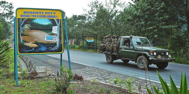 Rwandan soldiers pass a sign welcoming drivers to the city of Gisenyi, on the border with the Democratic Republic of Congo on August 30, 2013. Southern African nations have expressed concern at the growing number of Rwandan troops on the border of the Democratic Republic of Congo and said it hoped an invasion was not imminent.