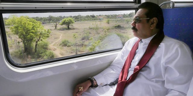 Sri Lankan President Mahinda Rajapakse sits on board a train en route to the former rebel capital of Kilinochchi, on September 14, 2013, in a photo released by the President's Office. A train linking the political home of Sri Lanka's Tamil Tiger rebels with the rest of the island rolled into service on Saturday after a 23-year interruption, officials said.