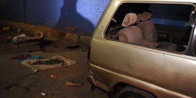 A damaged vehicle at the scene of a grenade attack in Kigali, Rwanda on September 13. One person was killed in the attack.