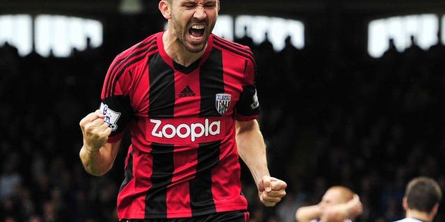 West Bromwich Albion's Northern Irish defender Gareth McAuley celebrates scoring the equalising goal during the English Premier League football match between Fulham and West Bromwich Albion at Craven Cottage in London on September 14, 2013. The match ended in a 1-1 draw.