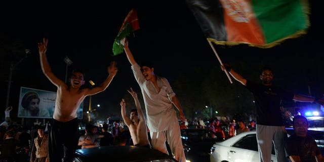 Afghan football fans celebrate winning the SAFF Championship 2013 trophy after their team defeatied India during the final match, in the streets of Kabul on September 11, 2013.