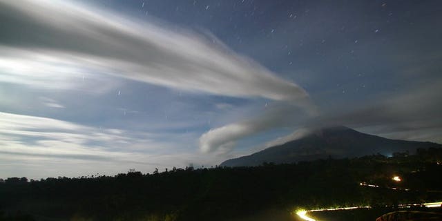 File picture shows plume of volcanic ash being emitted by Mount Sinabung in Tanah Karo district in North Sumatra province, seen under moon light from in this time exposure taken late September 16, 2010.