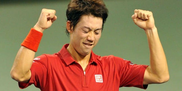 Japan's Kei Nishikori celebrates his win over Santiago Giraldo of Colombia after their Davis Cup World Group play-off in Tokyo on September 15, 2013. Nishikori beat Giraldo 6-1, 6-2, 6-4, propelling Japan back into the Davis Cup world group.