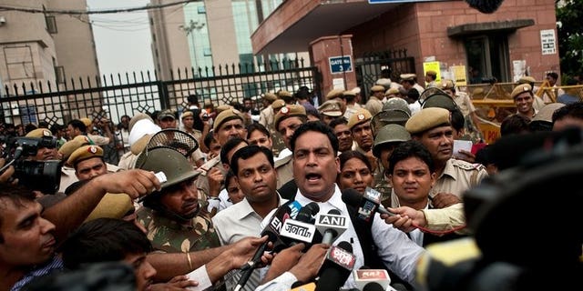 Indian defence lawyer A.P. Singh (C) addresses the media outside the Saket Court complex following the sentencing of four men convicted of rape and murder in New Delhi on September 13, 2013.