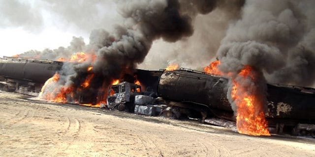 Smoke and flame rise from burning NATO supply oil tankers in Soorab town of Kallat district on September 13, 2013.
