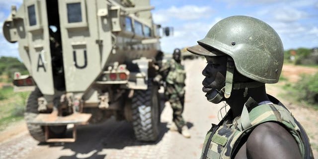 Ugandan soldiers, part of the African Union Mission in Somalia (AMISOM), patrol along the Afgooye-Baidoa road in Somalia on October 19, 2012. Uganda said it had suspended 24 of its army officers, who were part of a UN-mandated force battling Al-Qaeda linked rebels in Somalia, over corruption allegations.